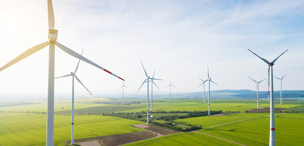 Aerial view of wind turbines and agriculture field